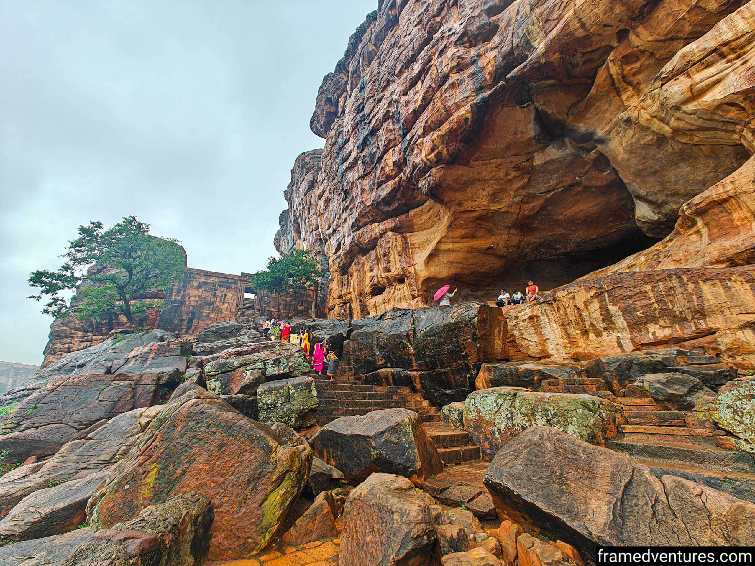 People climbing stairs adjacent to the Badami Cave Temples