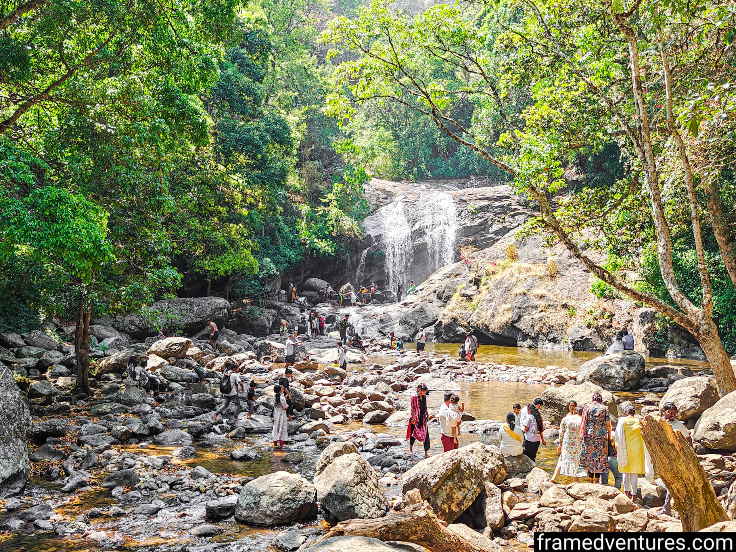 Tourists at Lakkam Waterfall in Munnar