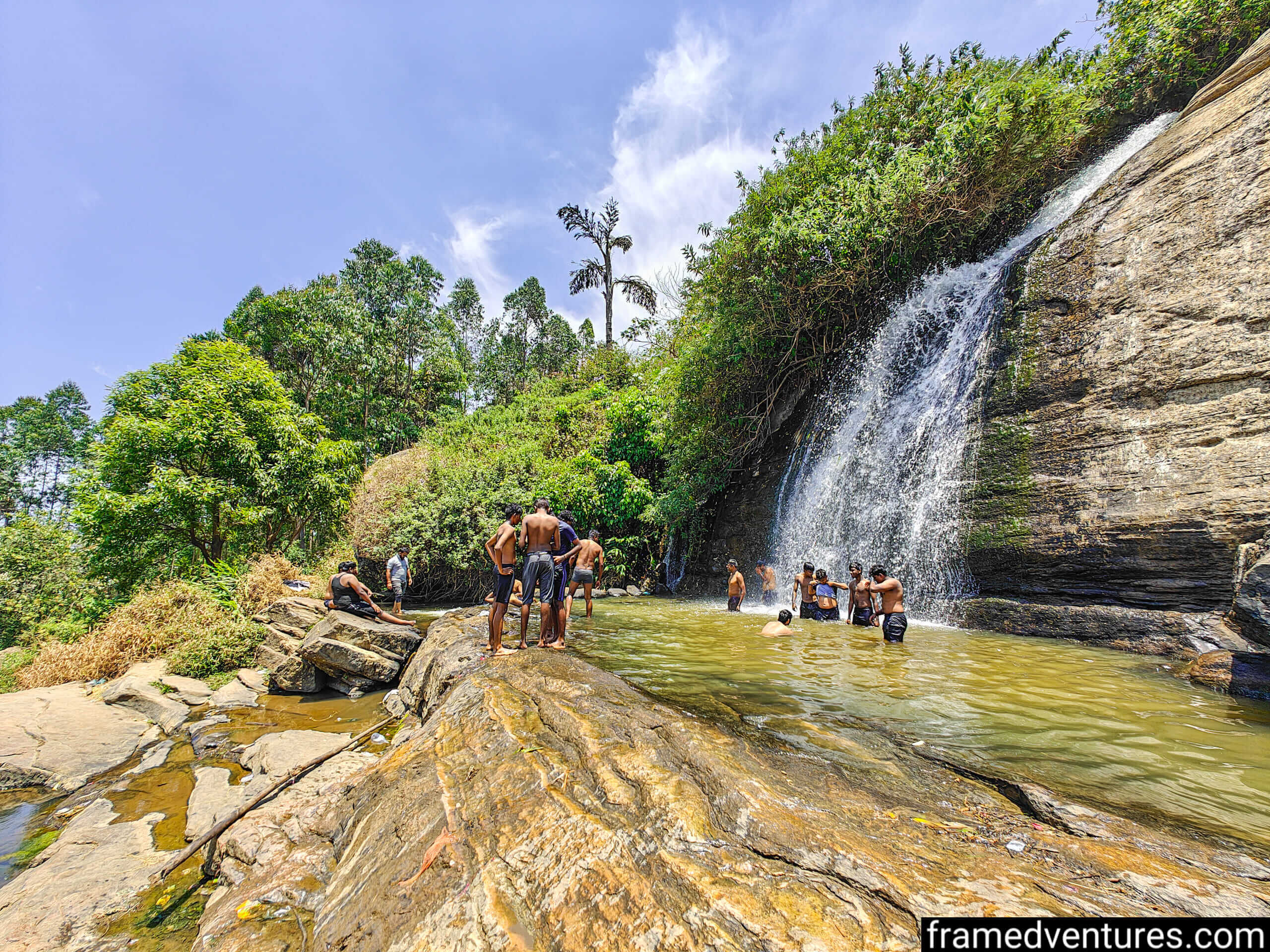 Tourists taking a dip at Kanthalloor Waterfall